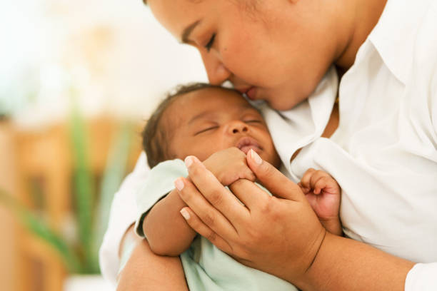 Mother cuddling infant tenderly