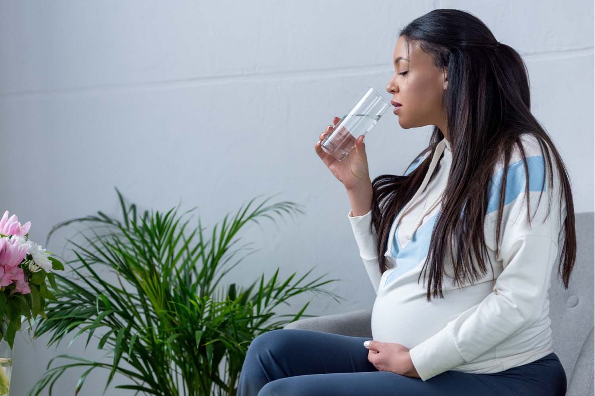 A pregnant woman drinking water